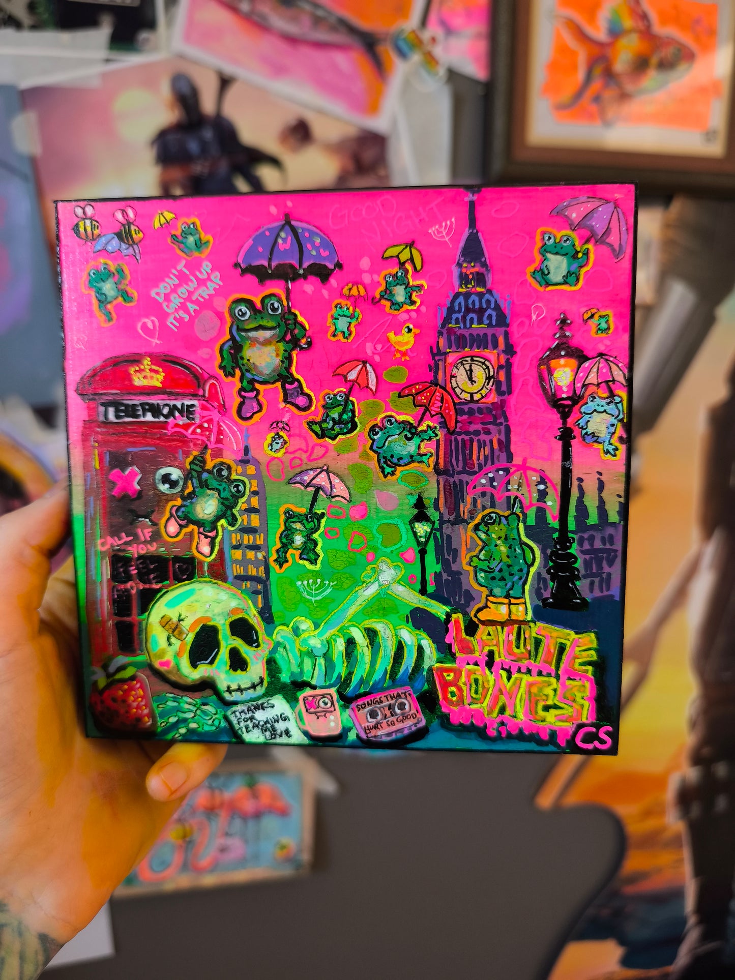 Surreal frog rain original artwork in Candy Decay style by Paintranger, colorful cute creepy painting on wood panel with frogs, umbrellas and whimsical rainy sky details

