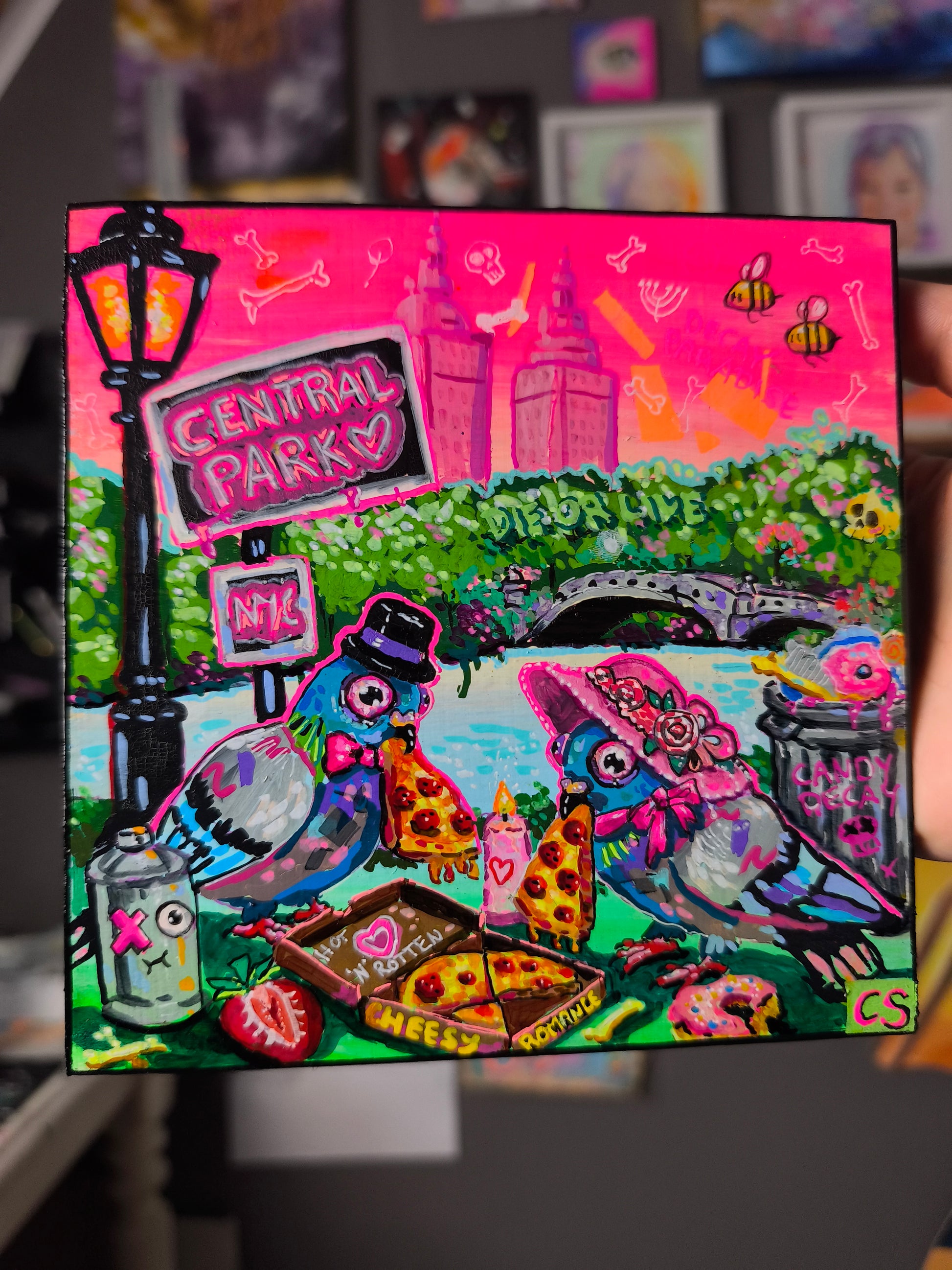 Surreal pigeon love original artwork in Candy Decay style by Paintranger, colorful cute creepy painting on wood panel with two pigeons having a candlelight dinner in Central Park New York