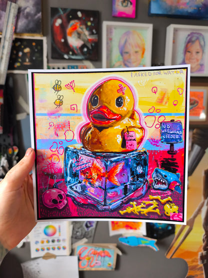 Colorful surreal rubber duck artwork featuring a cute duck sitting on an ice cube with a goldfish frozen inside, surrounded by bright candy colors and playful details. A hand signed Candy Decay art print about nostalgia, childhood memories and cute creepy storytelling.