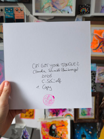 Colorful pop-surreal artwork titled Cat Got Your Tongue? featuring a large black cat with a skull-like face staring over a goldfish trapped inside a transparent plastic bag. Tiny furniture, including a pink armchair, lamp and vintage television, sits inside the bag beneath the fish. The background is neon pink and turquoise with handwritten doodles, bones, bees and playful symbols.