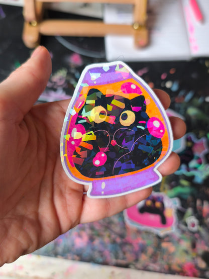 Close-up of a black cat in a colourful lava lamp with sparkling foil
