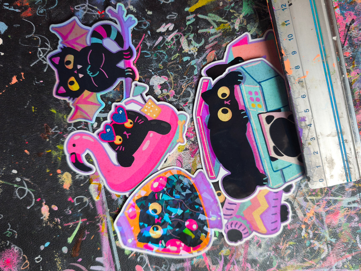 The black cat sticker set next to a ruler for scale