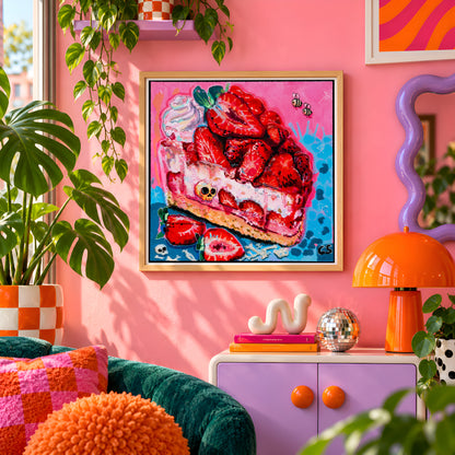 Strawberry Graveyard wall art print framed on a pink wall, featuring a strawberry cheesecake slice with tiny skulls, Candy Decay style by Paintranger