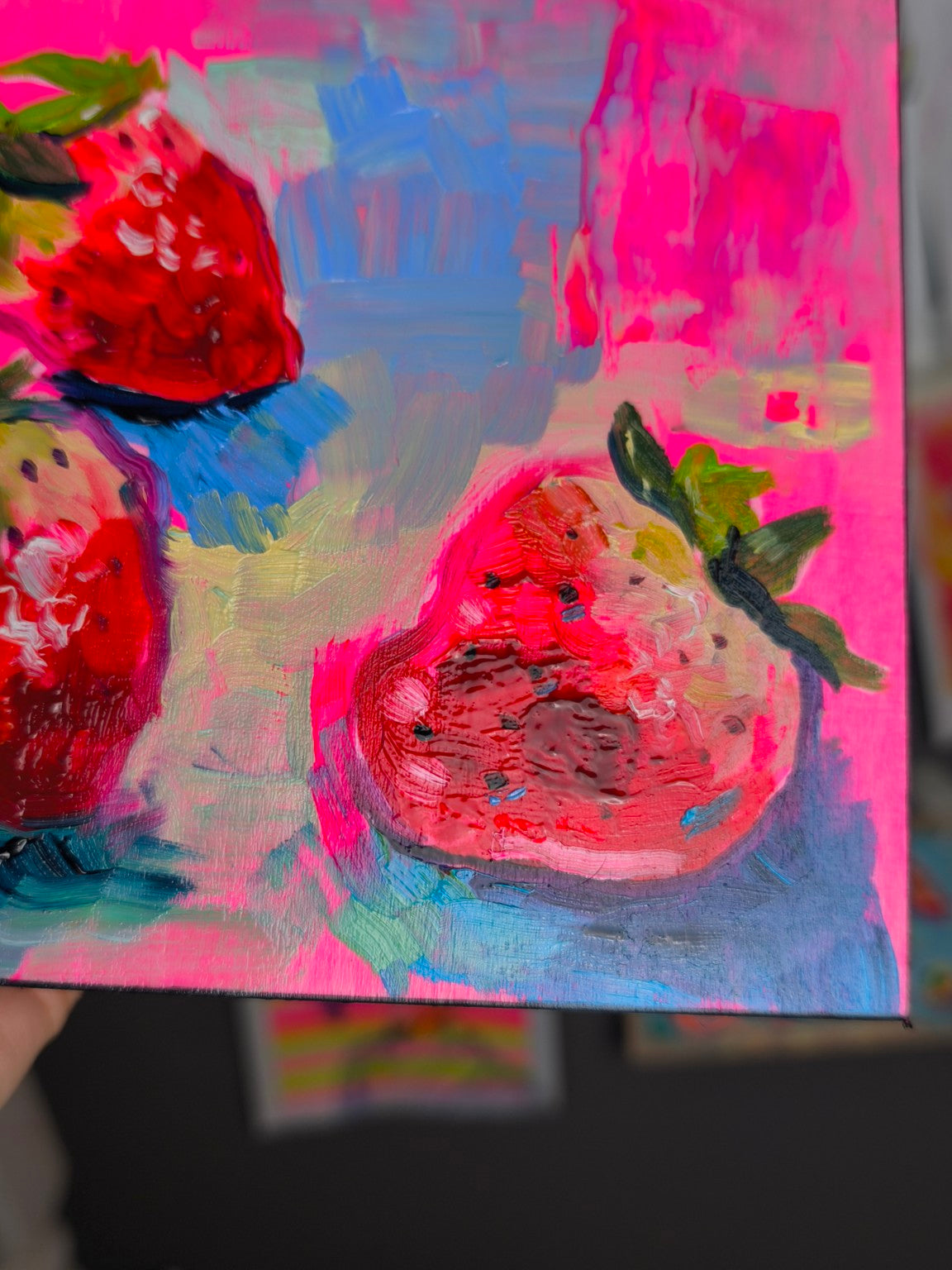Close-up detail of the strawberry oil painting showing brush texture and paint surface