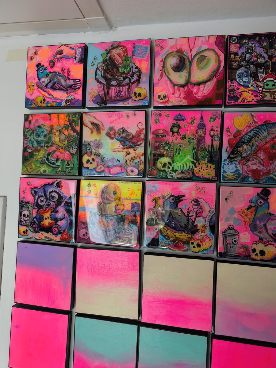 Finished works and prepared panels ready for new paintings.