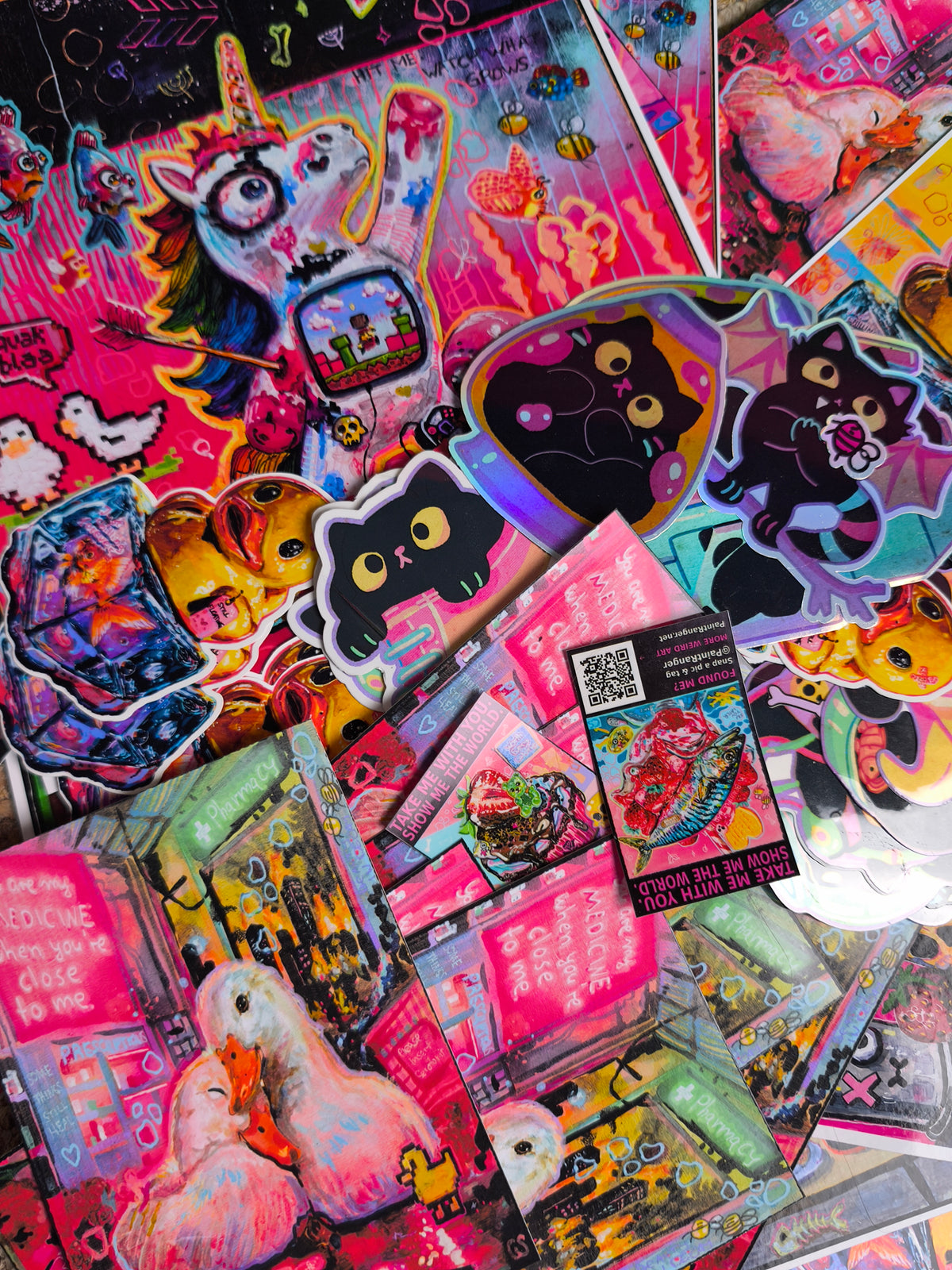 Example of possible mystery bag contents: colourful PaintRanger prints, stickers and postcards.